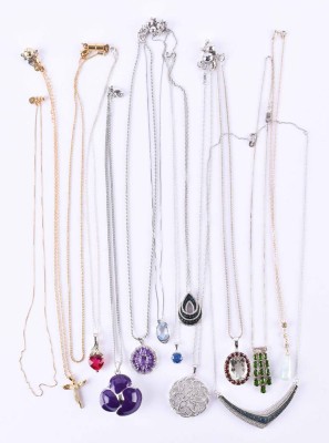 A group of silver necklaces