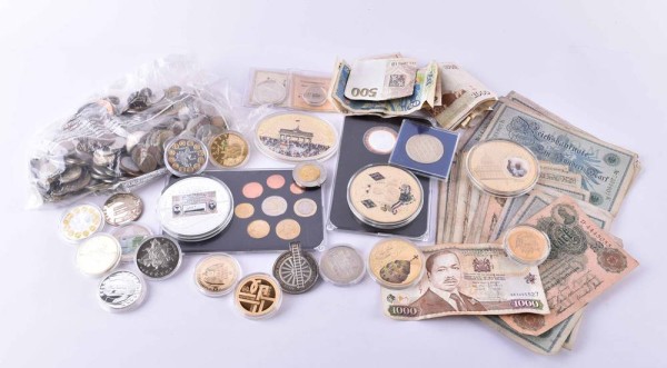 A group of coins, medals and banknotes