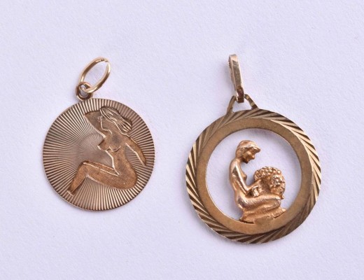 two zodiac sign pendants